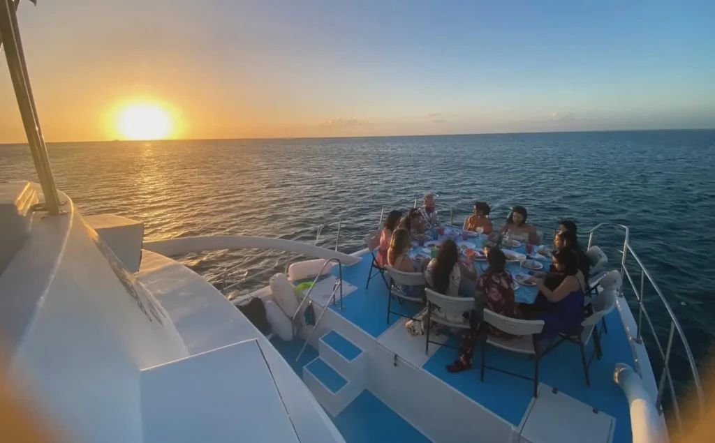 Private group enjoying a sunset dinner aboard La Dichosa
